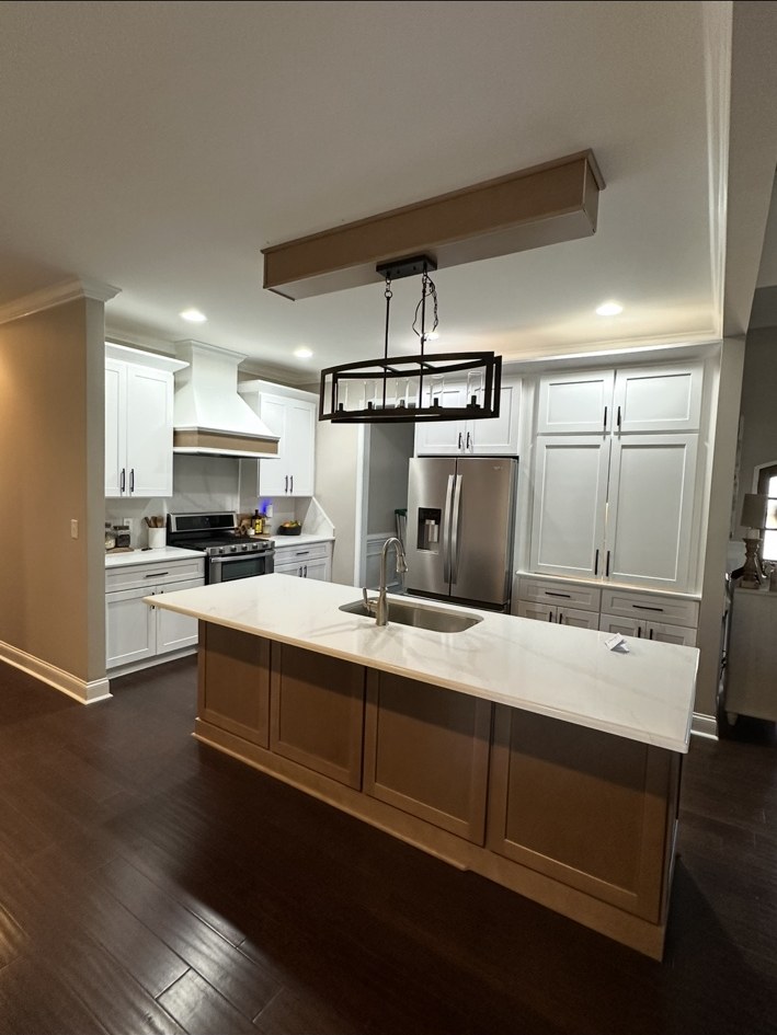 White kitchen cabinetry with a contrasting island