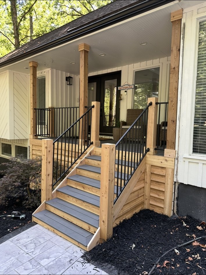 Front porch with wood posts and black railings