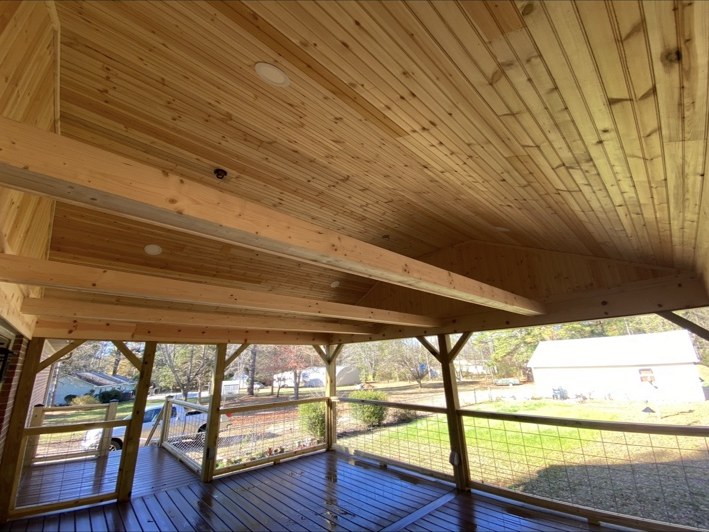 Exposed beams and wood porch ceiling