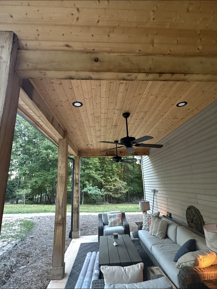 Inviting covered porch with wood ceiling and seating