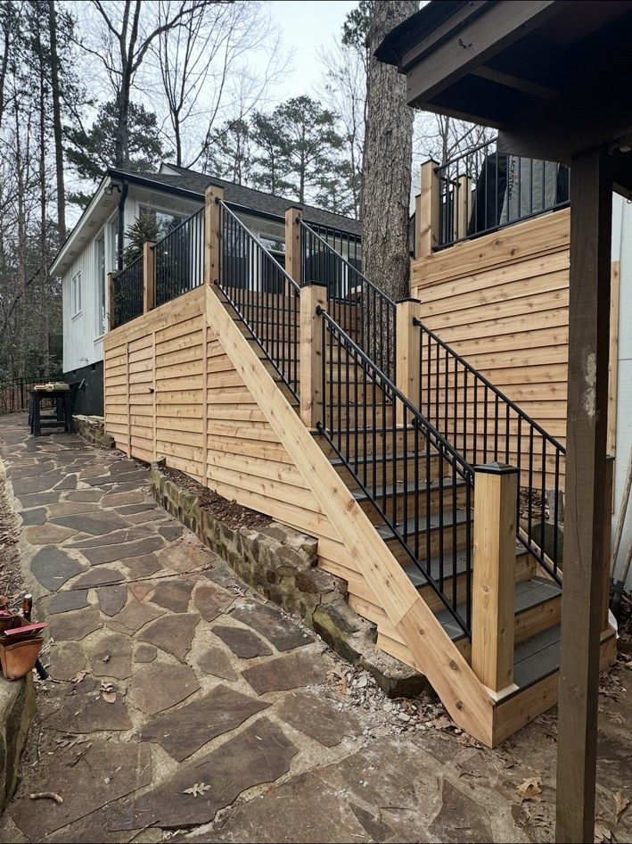 Deck stairs with wood and black railing